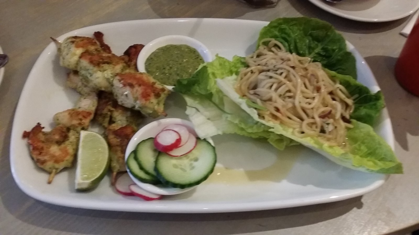 Chicken Satay with a Corriander based satay sauce and stir-fried noodles served on lettuce leaves