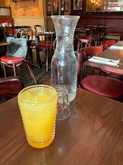 a photo of a passionfruitini and a carafe of water at Cafe Rouge