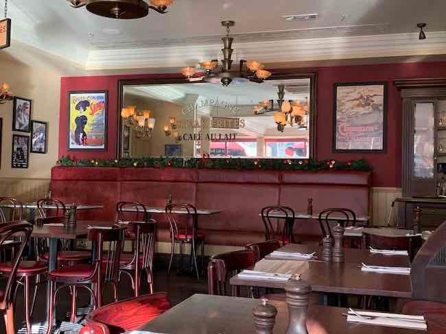 a photo of the inside of Cafe Rouge St Kathryn Docks showing the tables and a large mirror on the back wall